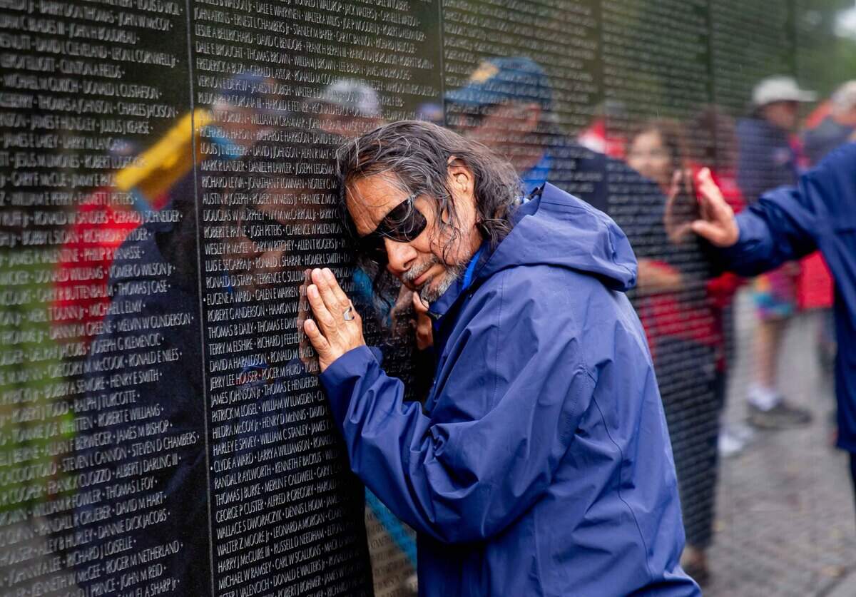 A veteran embraces the Vietnam Veterans Memorial during an Honor Flight Central Coast California trip to Washington, D.C. Bear McGill said many veterans open up emotionally while visiting memorial sites connected to their military service.