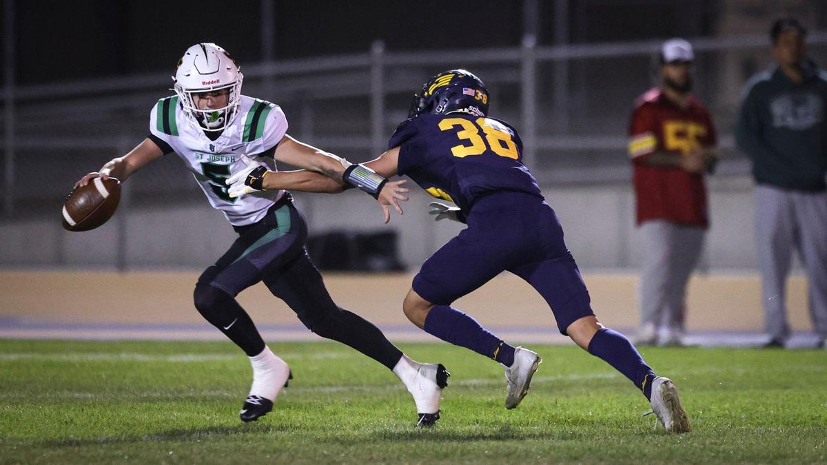 Quarterback Jack Heaslet gets pressure from Kaden Vegas Lechuga. Arroyo Grande beat St. Joseph 21-6 in a high school football game on Oct. 18, 2024.