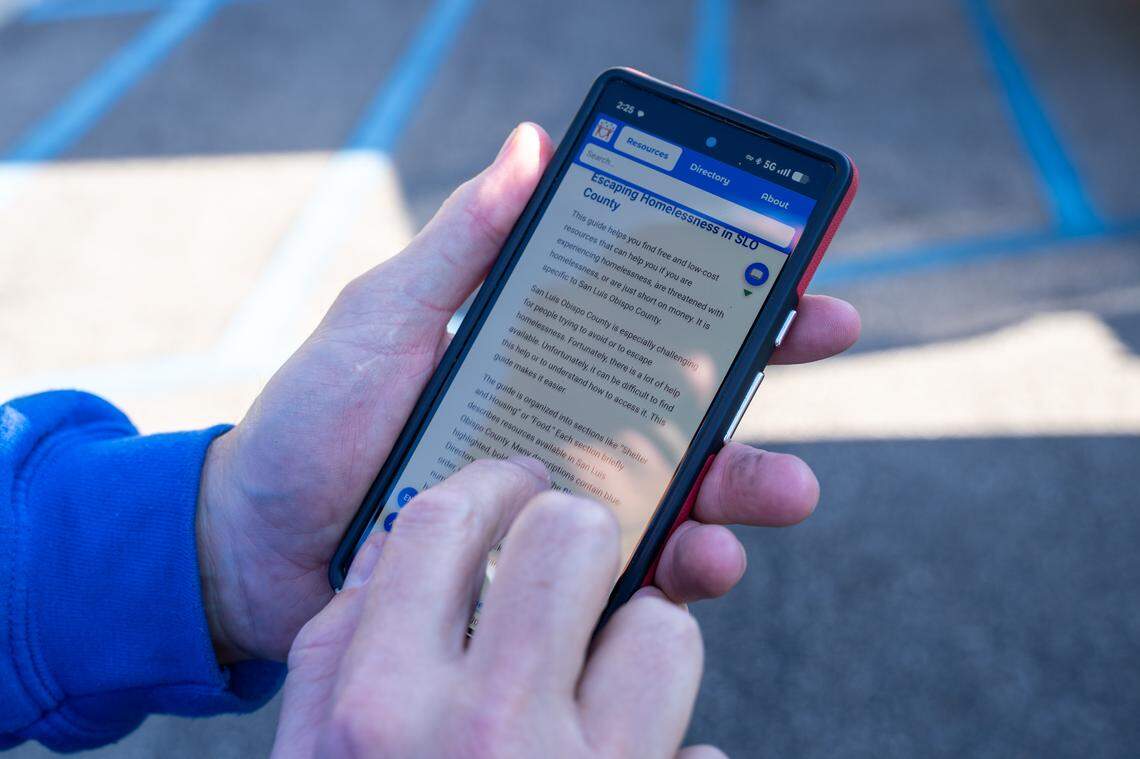 Shower the People operations manager David Gross shows how the VivaSLO website works on his cell phone on Thursday, Jan. 8, 2026. The website is a comprehensive guide to accessing homeless resources in San Luis Obispo County.