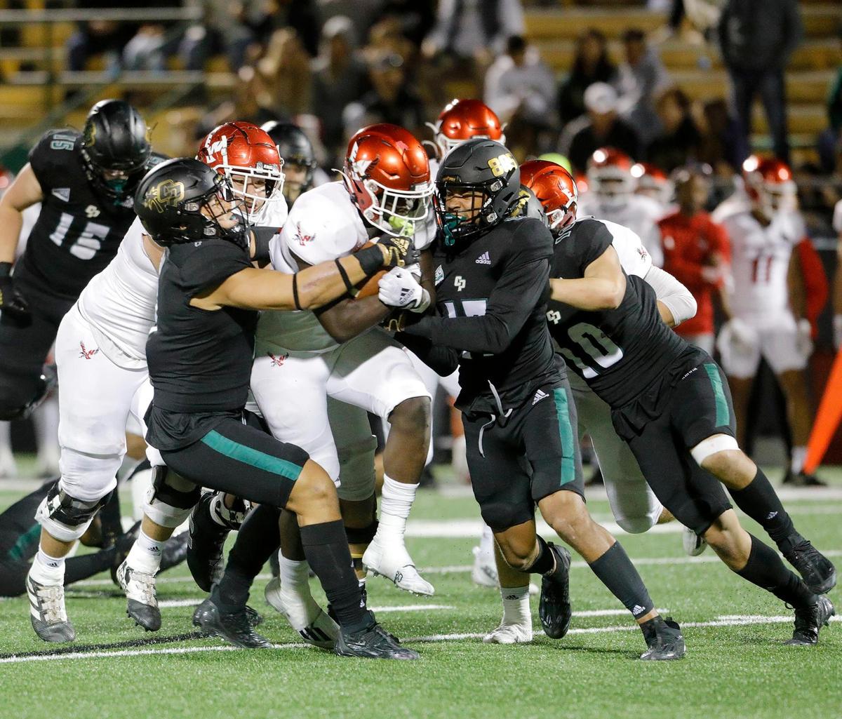 Laipeli Palu (7) and Isaiah Hogan (17) take down the Eagles’ ball carrier. Cal Poly lost to Eastern Washingon 17-10 in a Big Sky Conference football game at Alex G. Spanos Stadium in San Luis Obispo, Saturday, Oct. 22, 2022.