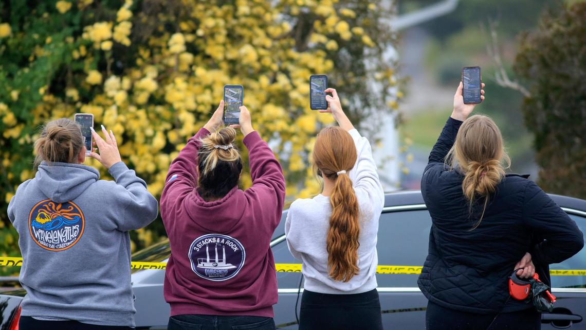 Spectators gather and make videos of the investigation scene at the Arroyo Grande home of Ruben Flores on Tuesday, April 13, 2021. Flores is the father of Paul Flores, considered the prime suspect in the disappearance of missing Cal Poly student Kristin Smart.
