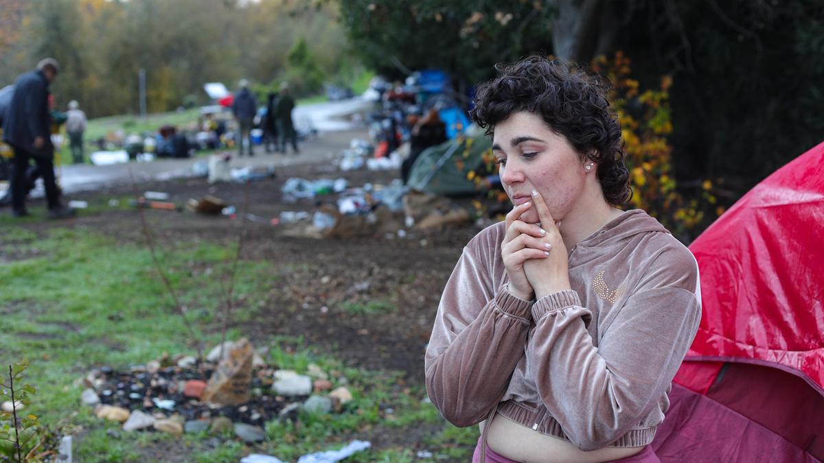 Ashlynn Miles, 21, considers her future living arrangements as workers dismantle homeless camps on the Bob Jones Trail in San Luis Obispo. Camps were torn down on Jan. 7, 2022, in advance of work along the creek to reduce fire risk, upgrade trail fencing and improve flood control.