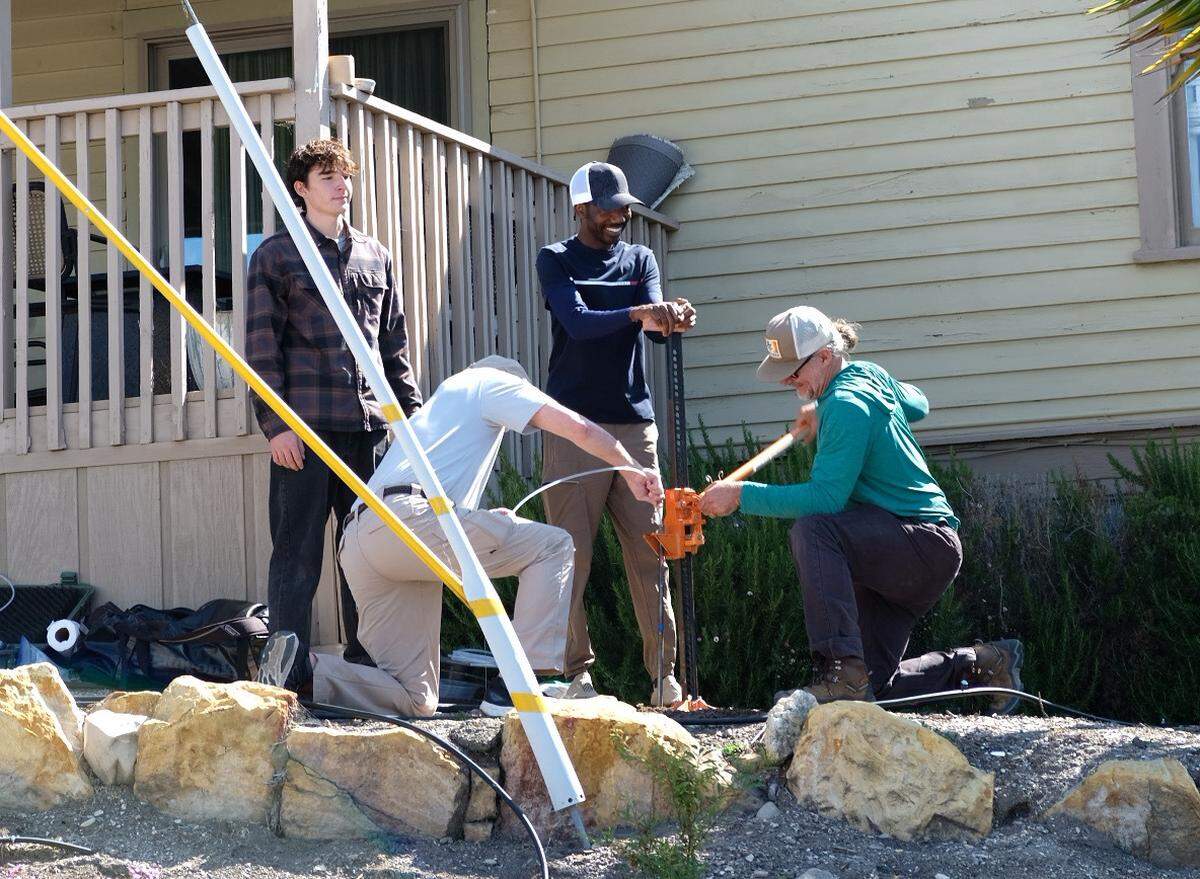 Jacob Negillan, left, Brian Eckenrode, Edward Bentil and Timothy Nelligan test the soil in the front yard of the house next door to Susan Flores’ home in Arroyo Grande on Thursday, May 7, 2026, during the second day of a search warrant investigation in the Kristin Smart murder case.