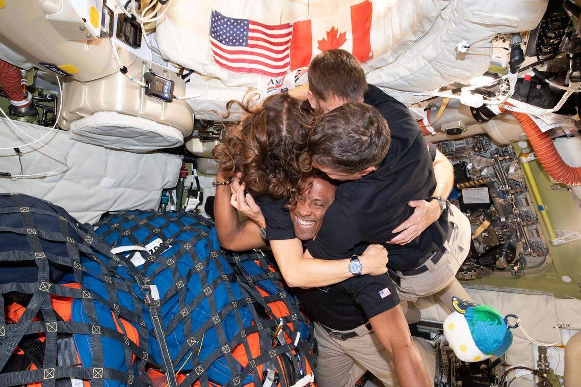 The Artemis II crew — clockwise from left, Mission Specialist Christina Koch, Mission Specialist Jeremy Hansen, Commander Reid Wiseman, and Pilot Victor Glover — take time out for a group hug inside the Orion spacecraft on their way home on April 7, 2026.