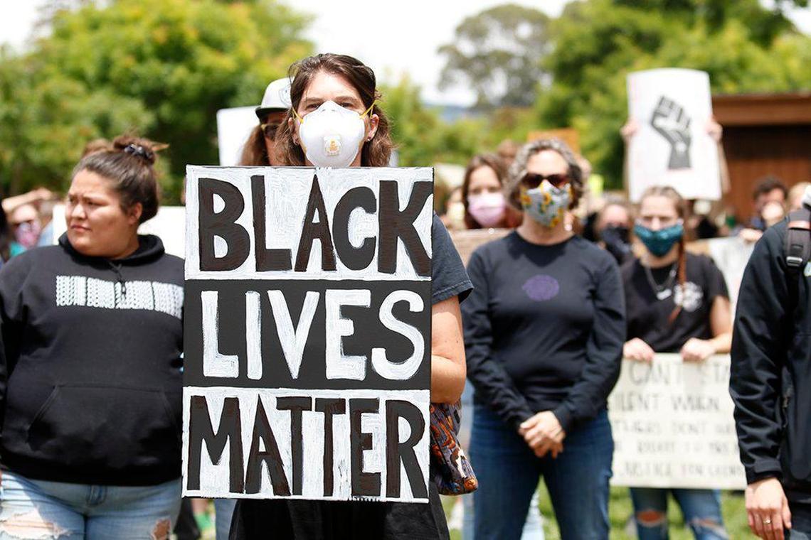 A large crowd listens to speakers at Mitchell Park in San Luis Obispo on Sunday, May 31, 2020.