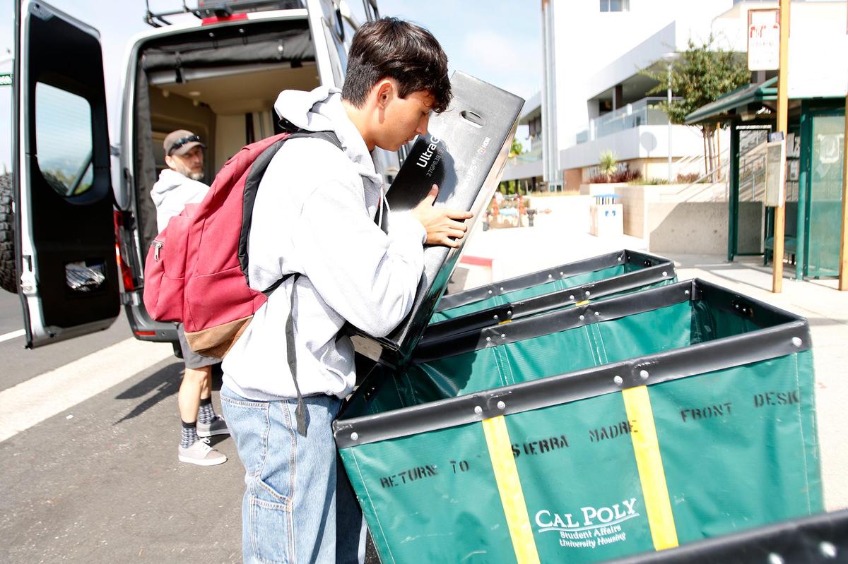 Jonas Thyssen, a Cal Poly electrical engineering major, packs his green move-in cart on Tuesday, Sept. 14, 2021. About 8,000 students are expected to move into on-campus housing this week at Cal Poly’s campus in San Luis Obispo.