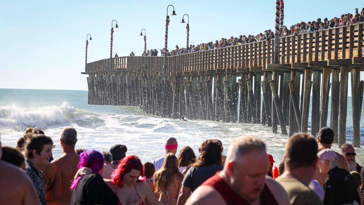 About 1,000 people celebrated the New Year plunging into the surf at Cayucos at the 44th annual Carlin Soulé Memorial Polar Bear Dip on Jan. 1, 2024, as roughly 2,000 more watched from the pier and the beach.