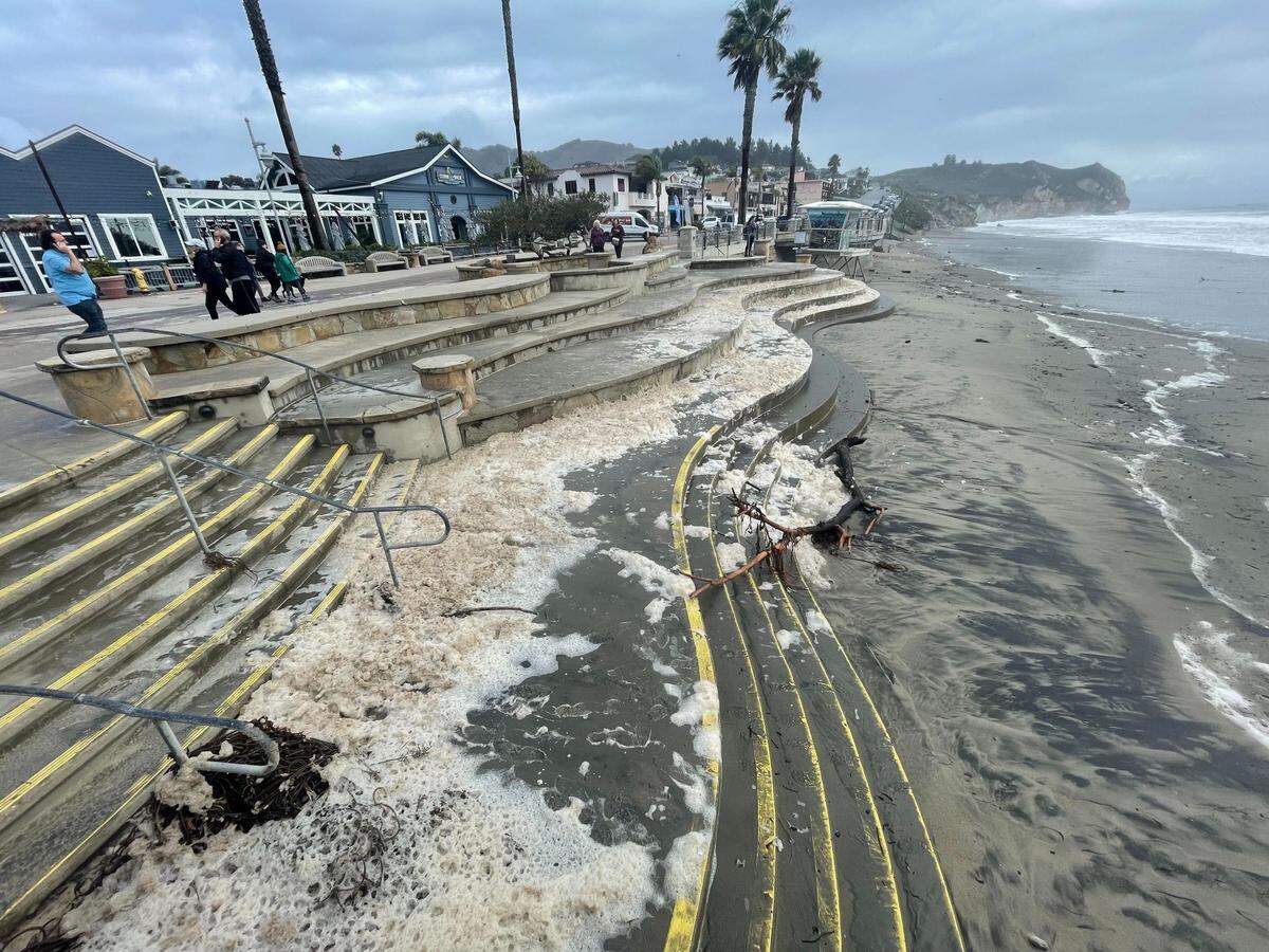 Giant swaths of marshmallow-like seafoam cover the steps leading to the beach in Avila Beach on Thursday, Jan. 5, 2023, following a powerful storm.