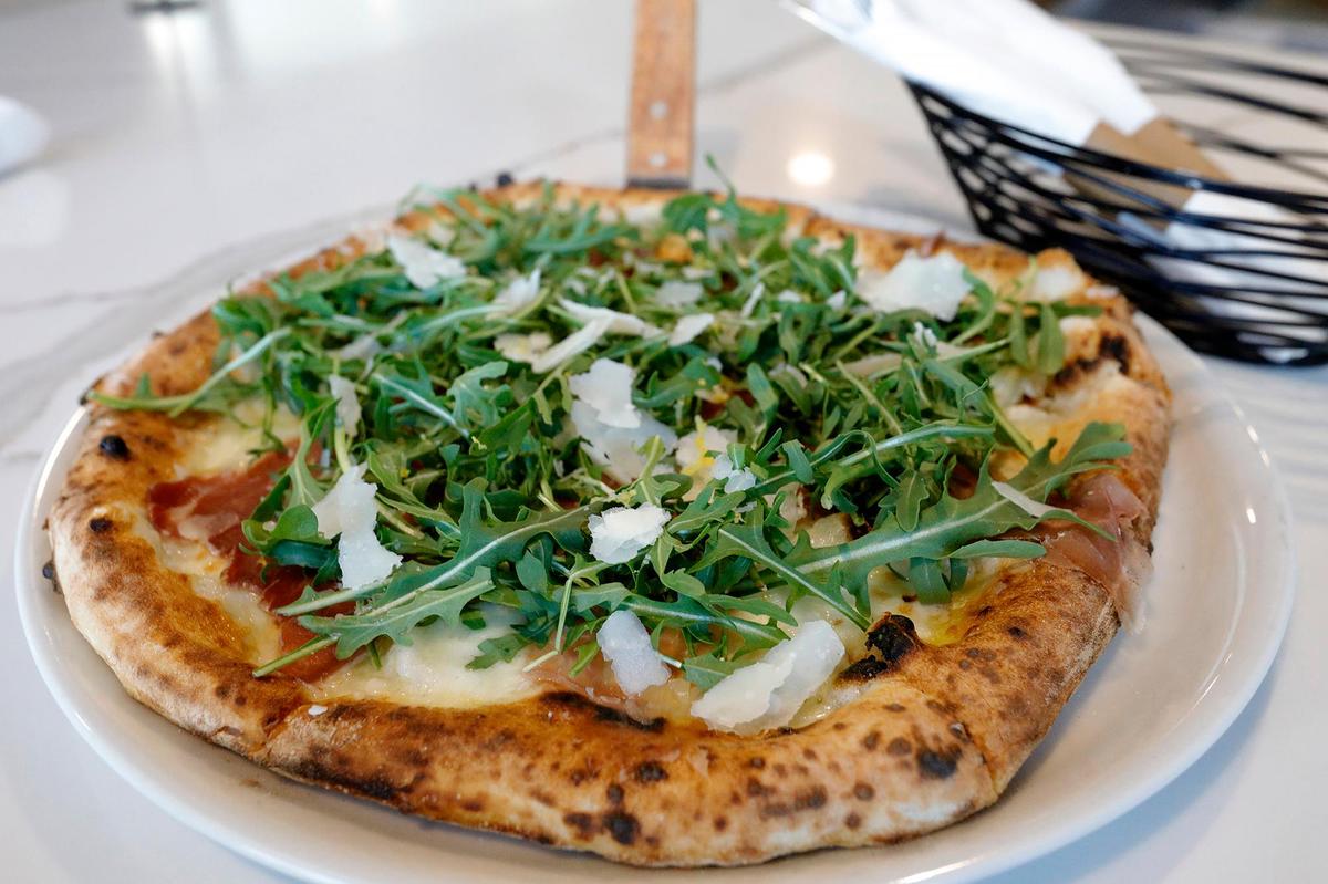 The Rucola al Limon is made fresh mozzarella di Bufala, scamorza affumictata(smoke mozzarella), fresh roasted cherry tomatoes, chopped garlic, Italian oregano, parsely, basil, pecorina romano and Ligurian DOP OVOO.