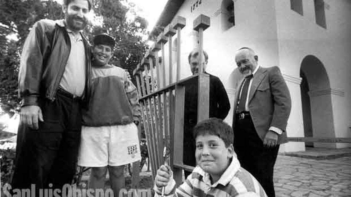 The lighting of a community menorah will take place in front of the Old Mission in San Luis Obispo every evening at 5:30 throughout Hannukkah, starting Monday. Helping erect the menorah are Rabbi Harry Manhoff of Congregation Beth David, left, with sons Shai, 11, and Eitan, 8, with wrench; the Rev. Jim Nisbet of the Old Mission Church; and Rabbi Bob Weinstein of Tenple Ner Shalom.