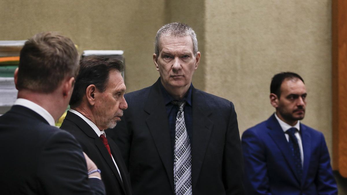 Stephen Deflaun, center, stands in San Luis Obispo Superior Court on March 30, 2023 during the trial against him for the 2001 killings of two people at the Morro Strand State Beach campground.