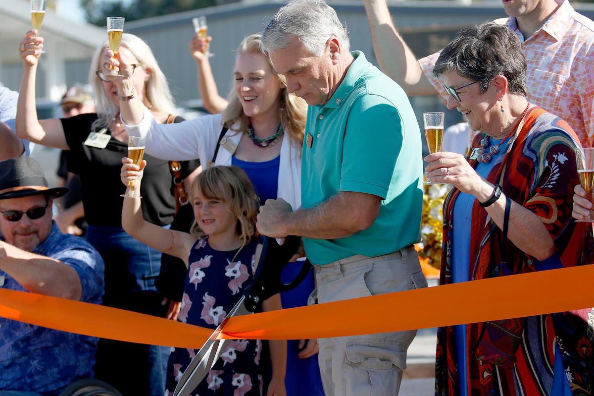 Atascadero Mayor Charles Bourbeau, center, handles the ribbon cutting Friday, June 27, 2025, as Atascadero completed its downtown makeover on El Camino Real with new parking, lights and greenery.