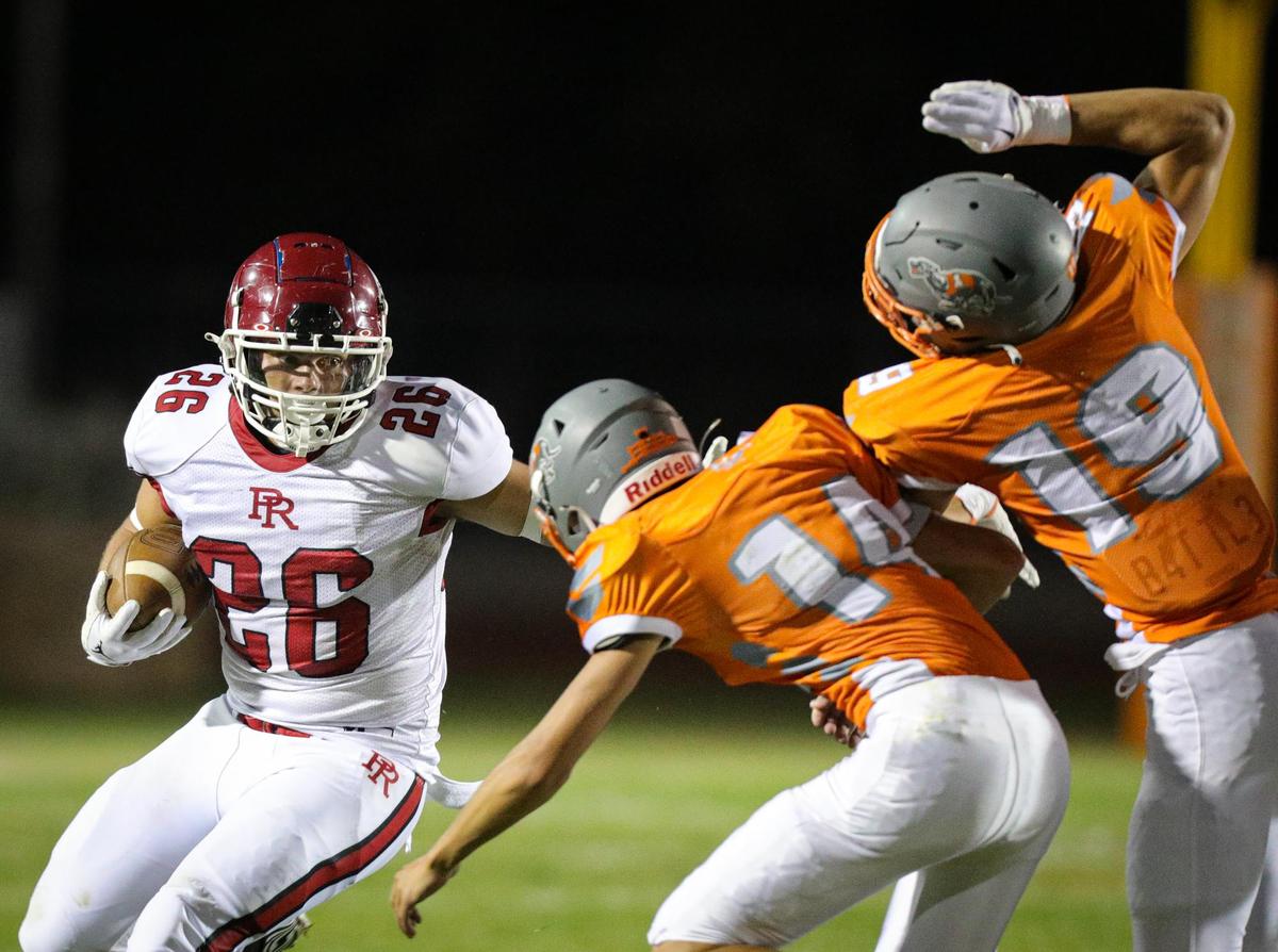 Leo Kemp runs as Mason Degnan and C.J. Bell pursue. In the annual rivalry game, Paso Robles beat Atascadero 35-21 on Sept. 2, 2022.