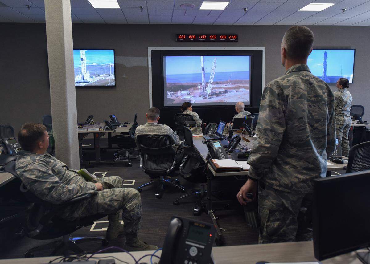 Col. Michael Hunsberger, 30th Mission Support Group commander, and Lt. Col. Jason Aftanas, 30th Civil Engineer Squadron commander, watch the Spaceflight SSO-A: SmallSat Express on a SpaceX Falcon 9 rocket at the Emergency Operation Center Dec. 3, 2018 at 10:34 a.m.