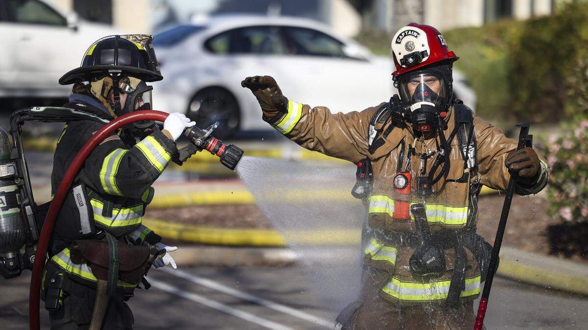 After a period of firefighting smoke is hosed off. Capt. Greg Baranek with the Avila Valley Station is hosed off. Firefighters were called to the former Tribune building on South Higuera, currently the offices of E/ S/ Aero on Jan. 12, 2026.