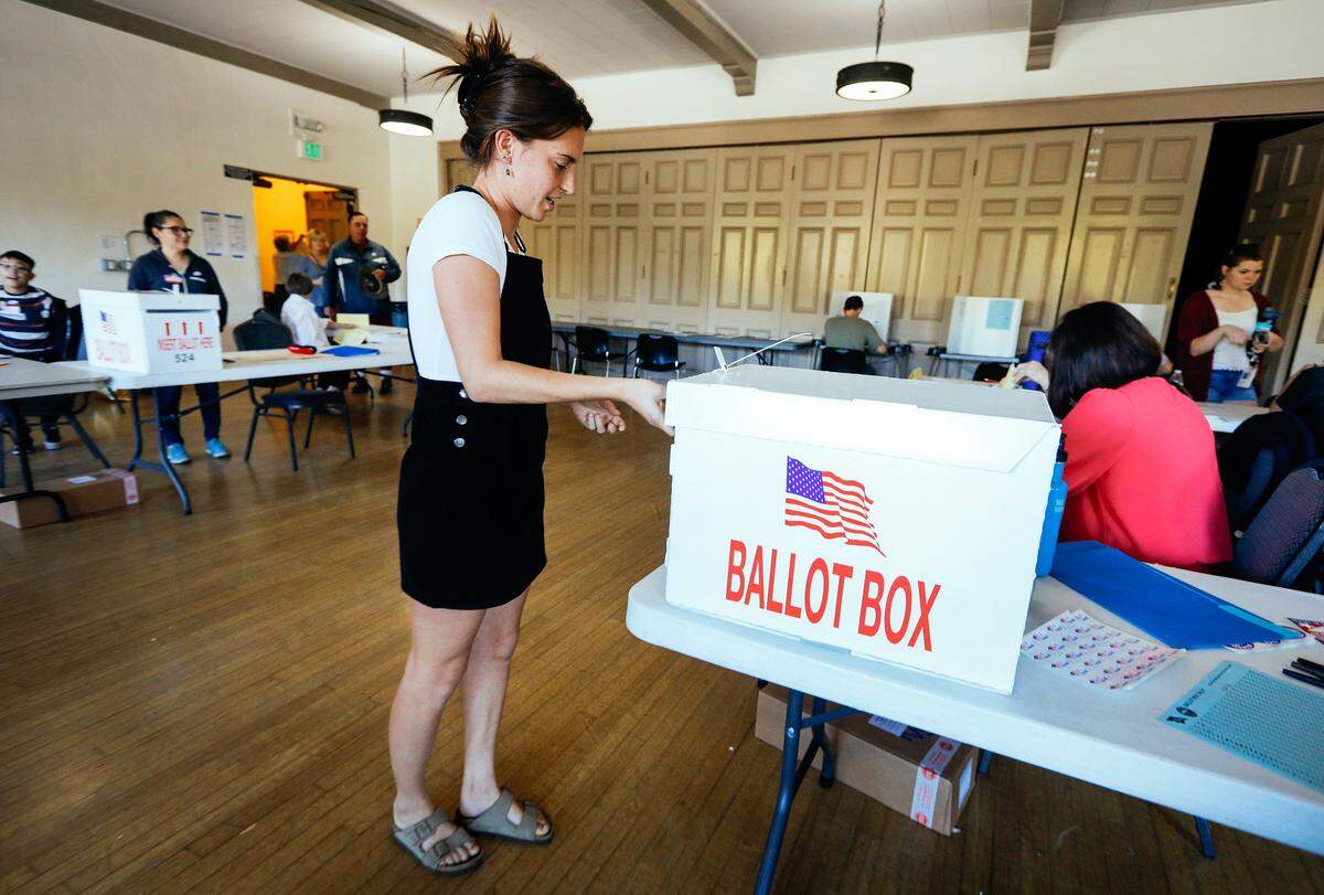 Brenna Merchant puts her ballot in the ballot box after voting Tuesday at the San Luis Obispo Veterans Memorial Building.