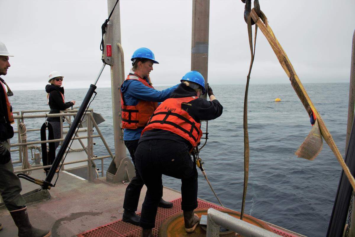 NOAA scientists Lindsey Peavey, left, and Lauren Roche, right, deploy a sound recorder into the Pacific Ocean on March 12 in the proposed Chumash Heritage National Marine Sanctuary.