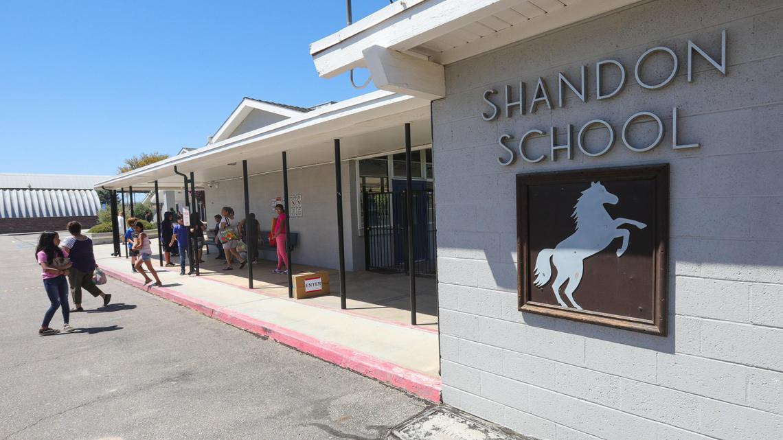 Shandon Elementary School students pick up homework packets and lunches on Thursday. The school provides paper packets for those without internet access.