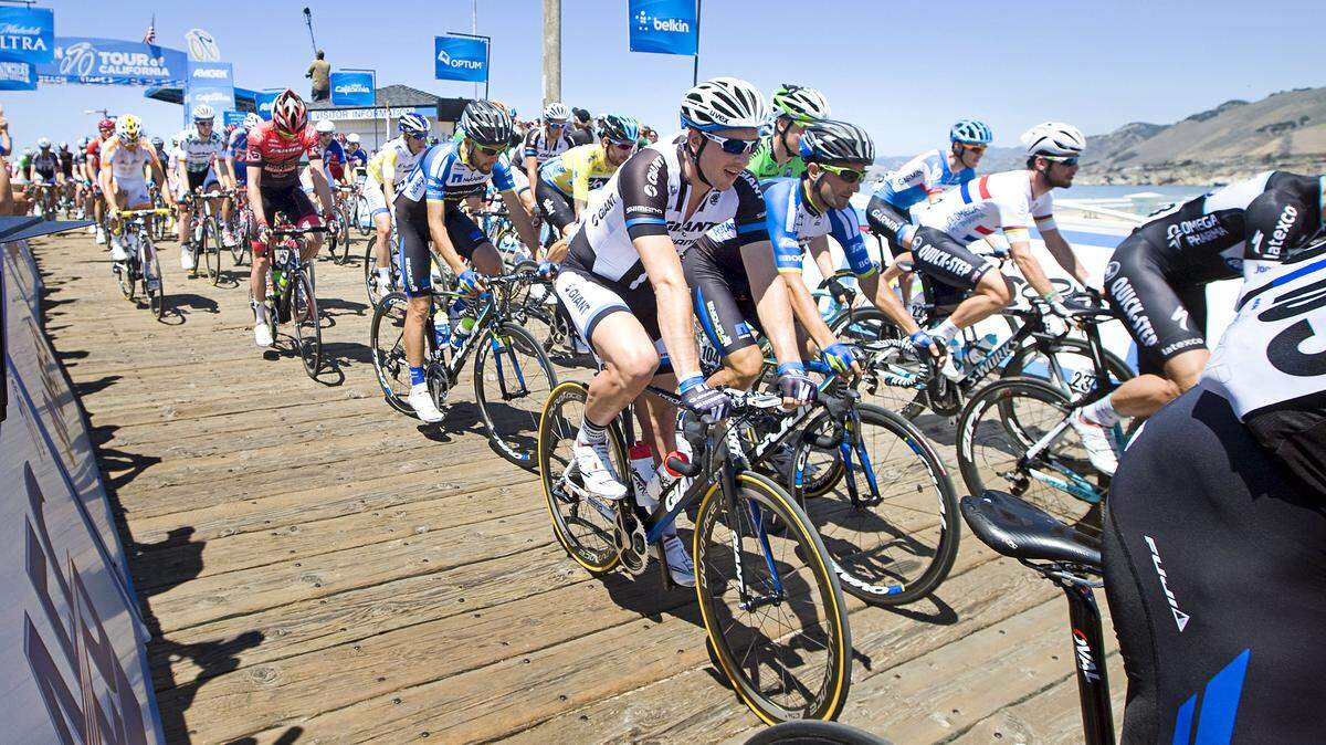 Riders head down the Pismo Beach pier at the start of Stage 5 of the Amgen Tour of California on Thursday, May 15, 2014.