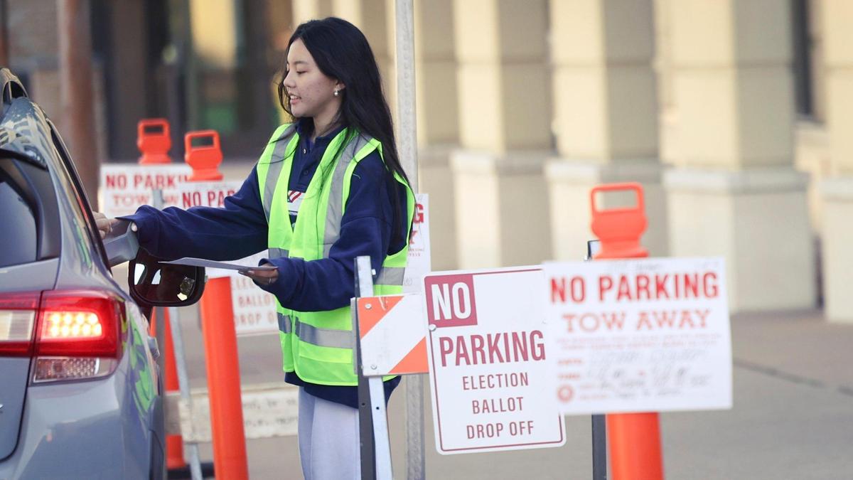 Poll worker Karen Lun is handed a ballot at the drop off point on Monterey St. Ballots were being collected at the San Luis Obispo Clerk-Recorder’s office at the Katcho Achadjian Government Center during the Super Tuesday election March 5, 2024.