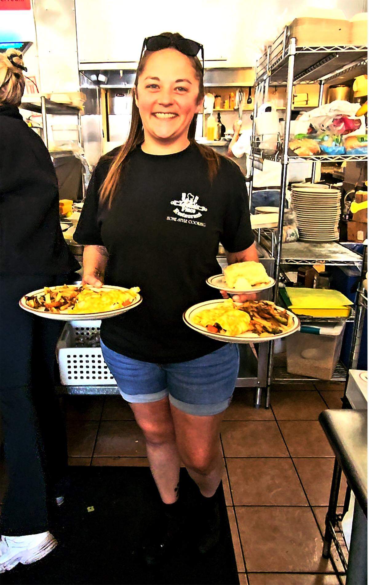 Louisa’s Place server Jess Jennings brings hot food out to diners.