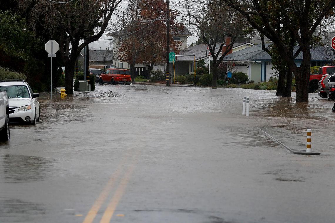 Oceanaire Drive is flooded with Laguna Lake water. The lake is up to the sidewalk on Madonna Road.