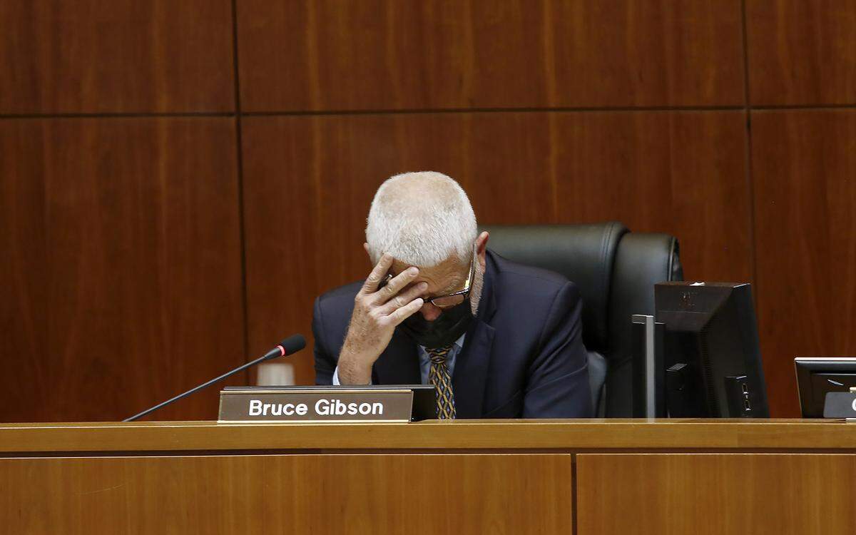 Supervisor Bruce Gibson holds his head while commenting during the San Luis Obispo County Board of Supervisors redistricting meeting on Nov. 30, 2021. Gibson and Supervisor Dawn Ortiz-Legg have been pushing for a political analysis of the redistricting maps to examine their partisan impact.