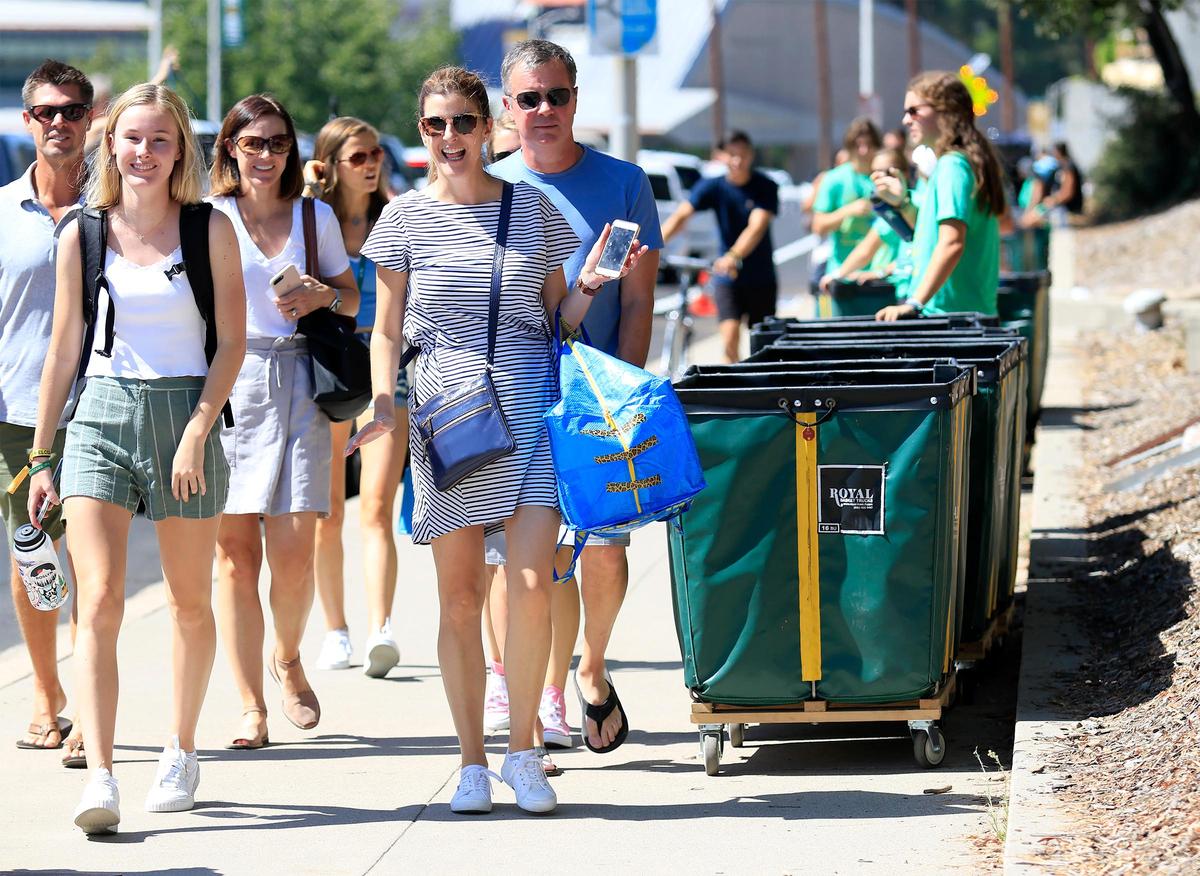 New and returning Cal Poly students move into their dorms ahead of the upcoming school year on a scorching hot Saturday afternoon in 2019. From left, Grace Munday, a biology major, and her mother, Alyson Munday, both of Seattle, walk toward the her new dorm room.