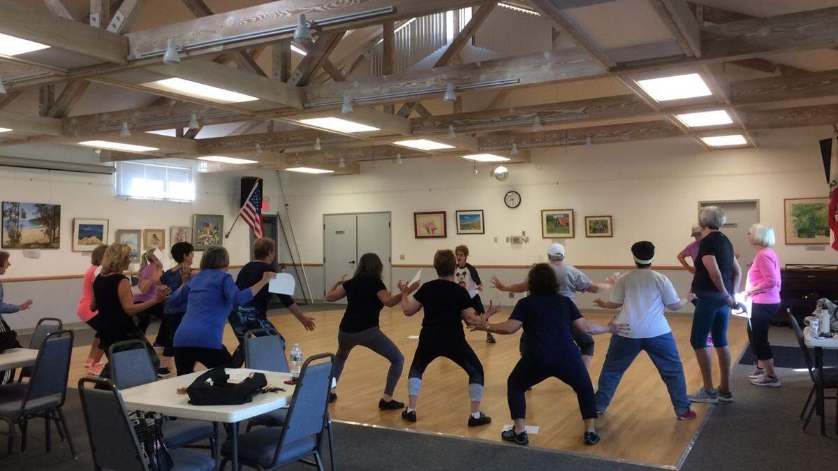 Lu-Ann Kelly leads members of the formerly named Newcomers Club, now the Cambria Neighbors Club, in dance moves they’ll be performing in this years Pinedorado parade.