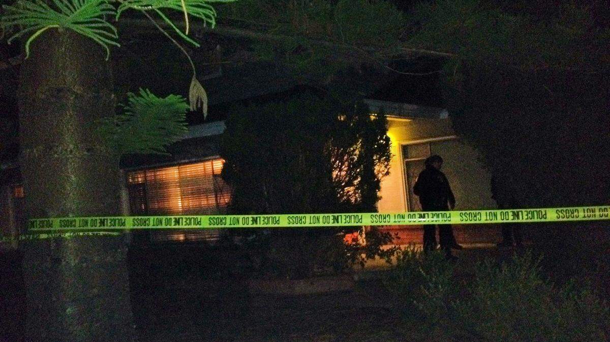 Crime scene tape is put up at the house where a shooting occurred Thursday, Nov. 21, 2013, near Cal Poly.