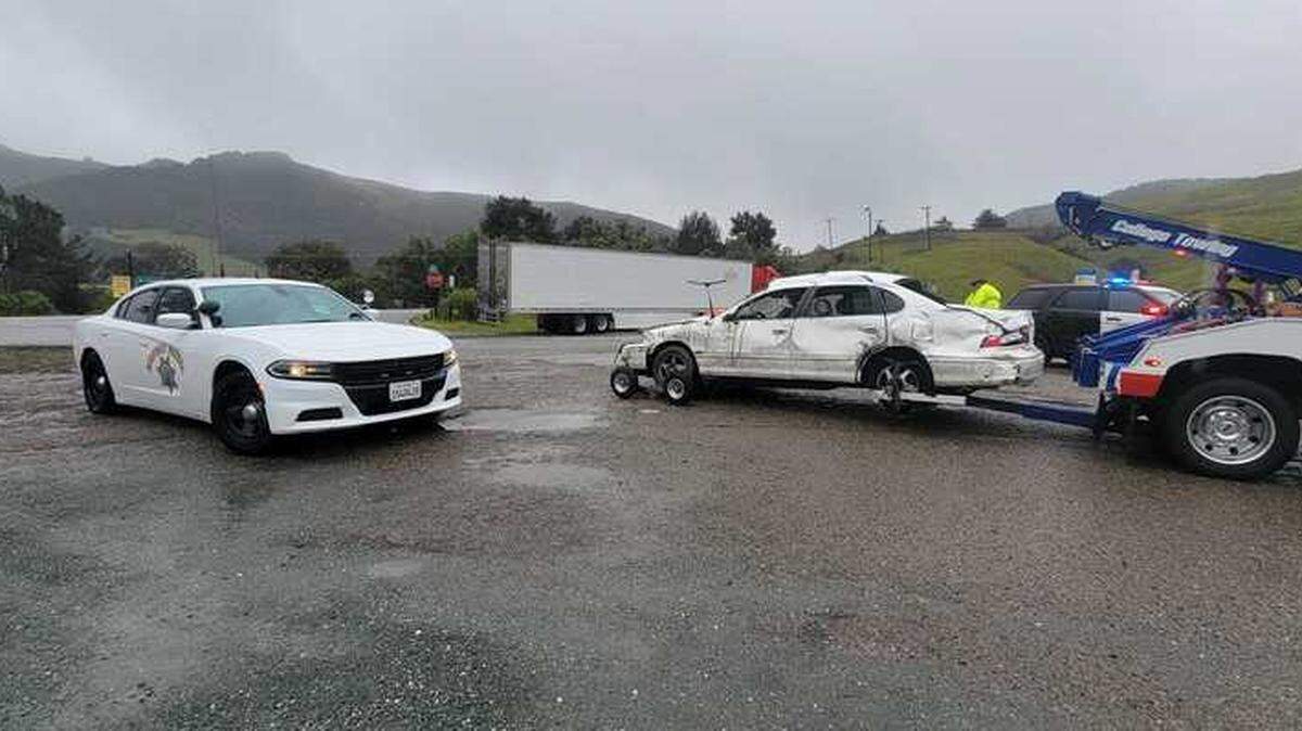 A car involved in a traffic collision near the South Higuera Street onramp sits on the roadside while being towed. Initial reports said the car involved in the collision drove up an embankment and flipped several times before landing on its roof.
