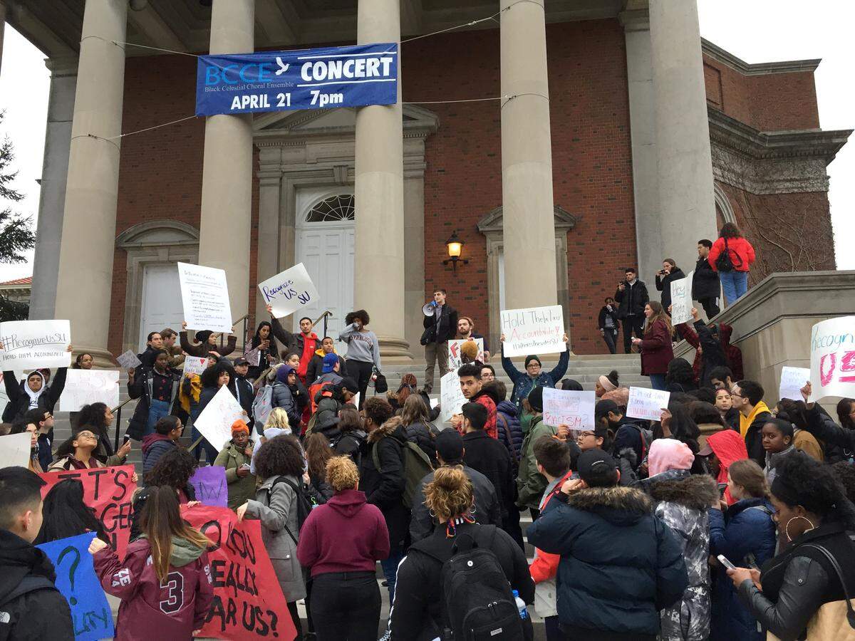 Syracuse University students gather outside Hendricks Chapel on Wednesday, April 18, 2018, to protest a video made by members of a now-suspended fraternity showing racist and sexist behavior in Syracuse, N.Y.  The school's chancellor, Ken Syverud, described the video involving members of Theta Tau, a professional engineering fraternity, as racist, anti-Semitic, homophobic, sexist and hostile to people with disabilities. He said the videos were turned over to the school's Department of Public Safety for possible disciplinary or legal action.