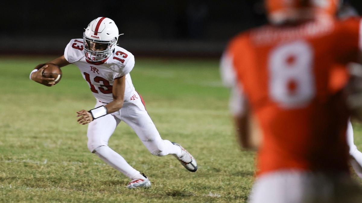 Quarterback Marcus Garcia scrambles away from pressure in Paso Robles’ 30-15 win over Atascadero in a high school football game on Sept. 20, 2024.