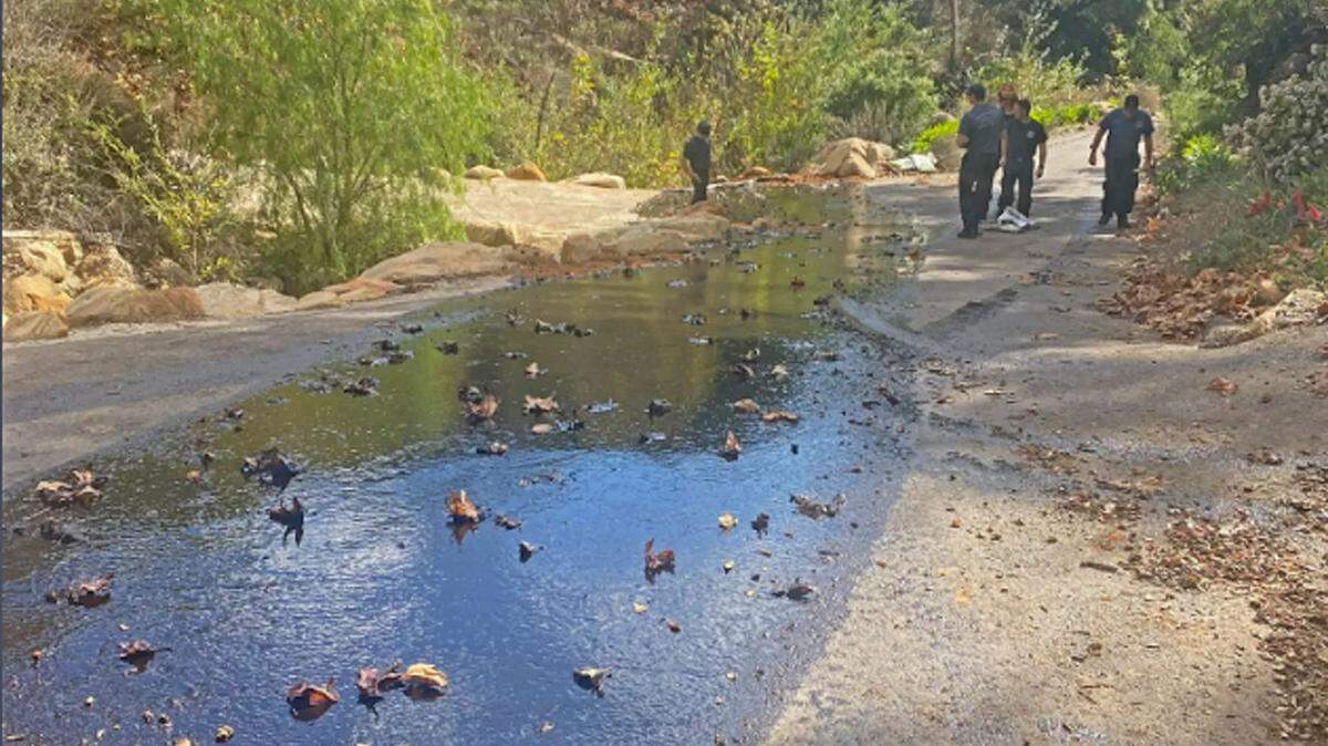 Emergency personnel tend to an oil leak in the area of Toro Creek in western Carpinteria.