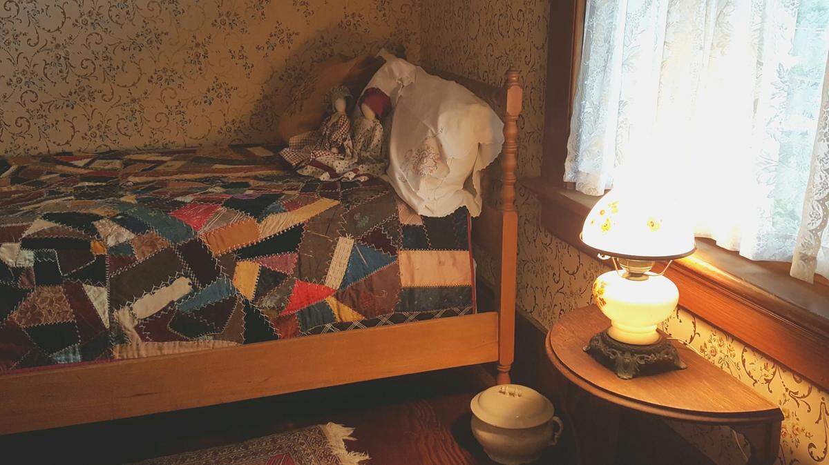 Step into the past, in the bedroom display furnished with a Soto family bed and 1880s quilt, complete with chamber pot.