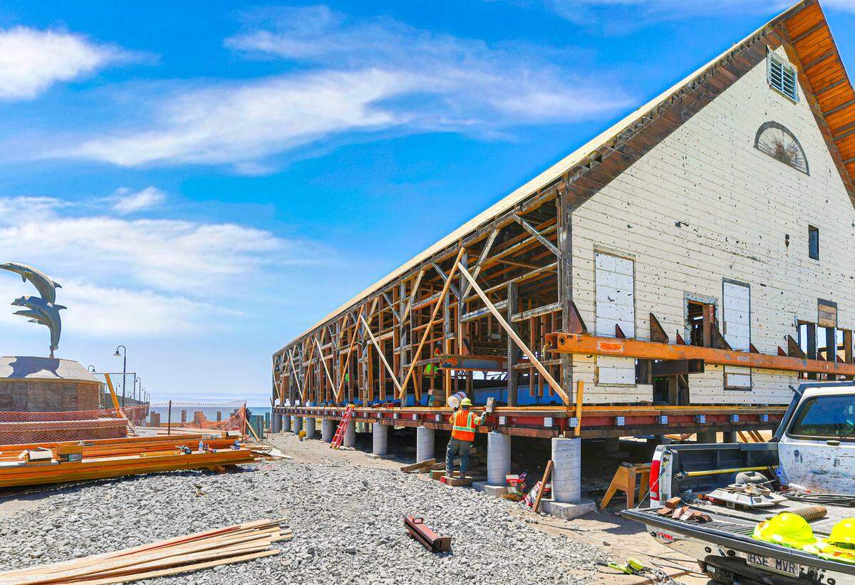 Crews work on the Cayucos Veterans Memorial Hall after its move to a new foundation on Wednesday, Aug. 2, 2023.