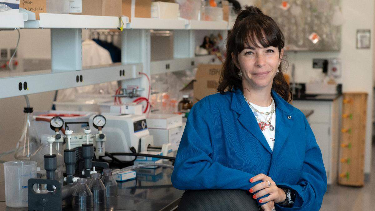 Joana Tavares poses for a picture in the Mackey Lab at the University of California, Irvine.