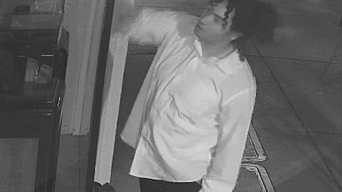 A person is seen vandalizing a business in downtown San Luis Obispo in a security camera image provided by the San Luis Obispo Police Department.
