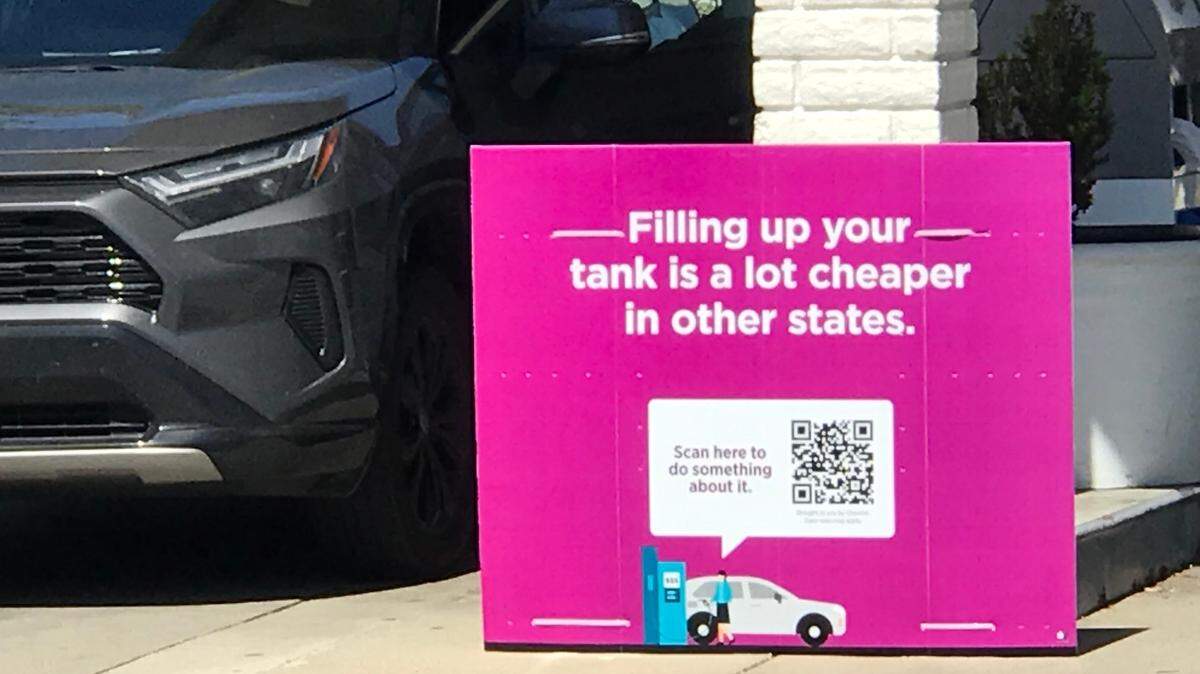 Big Oil has rolled out an advertising campaign that blames California’s gas taxes and environmental regulations for the high price of fuel. Here, a sign at a Chevron station in San Luis Obispo invites customers to learn more by scanning a QR code.