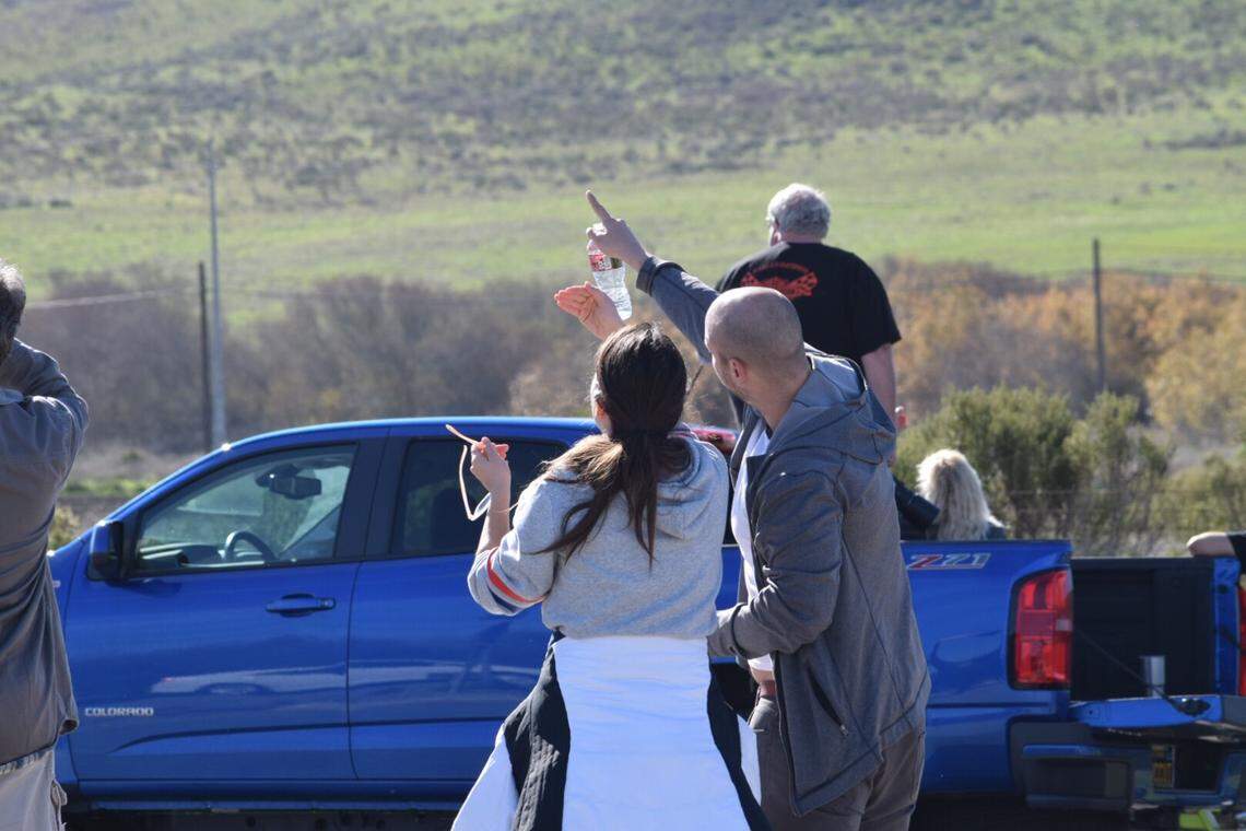 Onlookers along Ocean Avenue outside Lompoc gaze on as the Delta IV rocket hurdles into space Saturday morning.