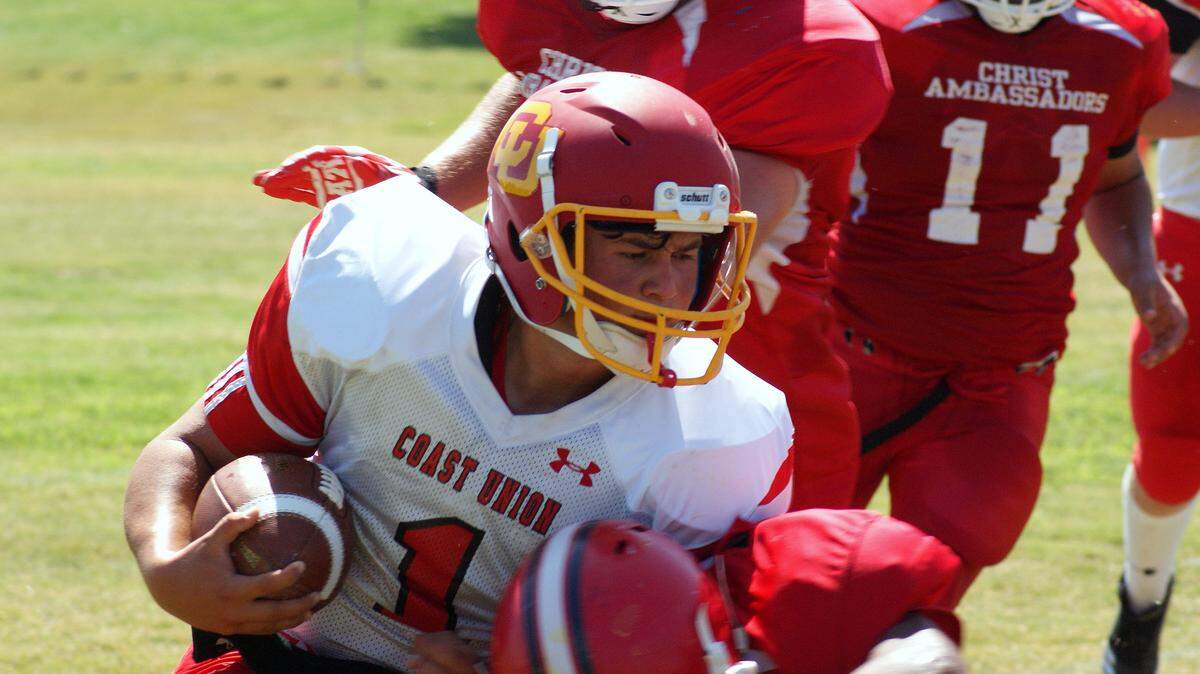 Coast Union High School quarterback Emany Plasencia struggled against a rugged defense Saturday Sept. 1, at  Riverdale Christian Academy. He netted just 18 yards rushing. Coast lost to Riverdale, 41-0.