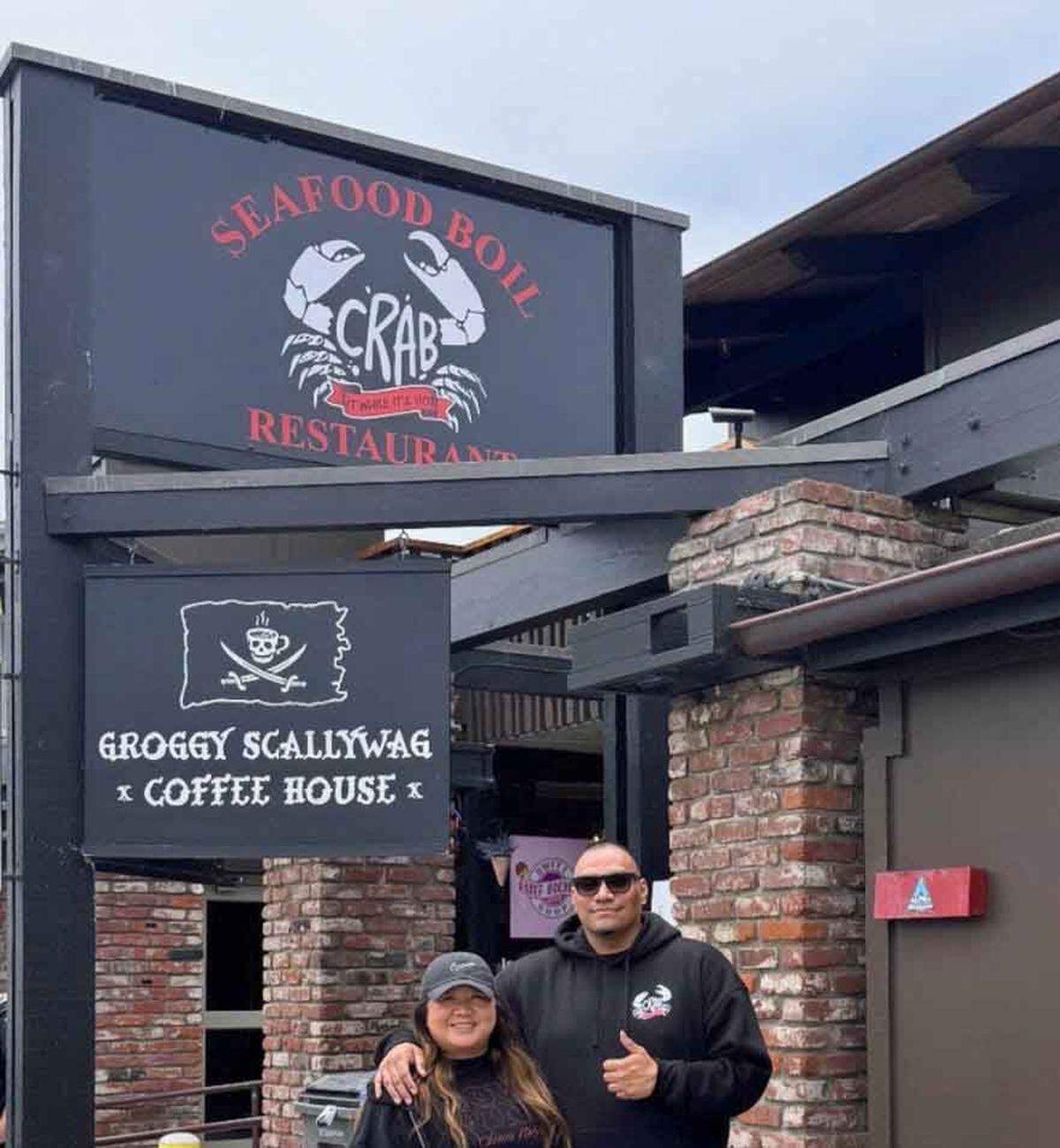 Sally and Presley Lara of Porterville give a thumbs up May 23, 2026, to their new Crab It While It’s Hot seafood restaurant in Morro Bay. It’s tentatively scheduled to open in July in a location near the Groggy Scallywag Coffee House. The couple, who have three other restaurants in the Central Valley, are doing a lot of the eatery’s remodeling prior to the launch.