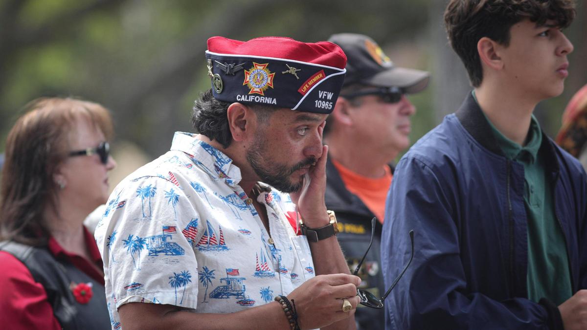 Veterans of Foreign Wars Paso Robles Post commander Leo Castillo wiped away tears as he reflected on a fellow veteran, Mike Mitchell, who died on April 4, 2004, in Baghdad, Iraq. Castillo named his son in memory of his fallen friend. About 250 people gathered at the Paso Robles District Cemetery on Memorial Day to honor the sacrifices of service members on May 26, 2025.