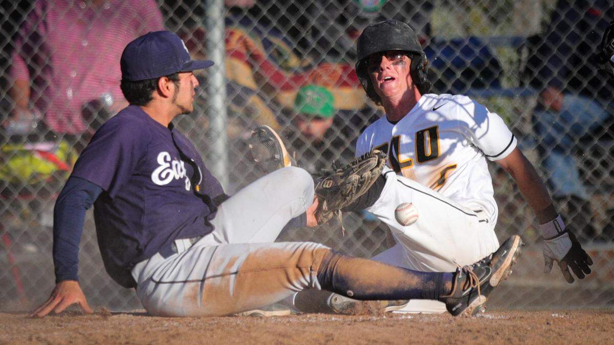 Bo Victor gets tangled with pitcher Kaden Tynes at home, Victor scored on the wild pitch. San Luis Obispo won 3-1 over Arroyo Grande in a baseball game in SLO May 12, 2022.