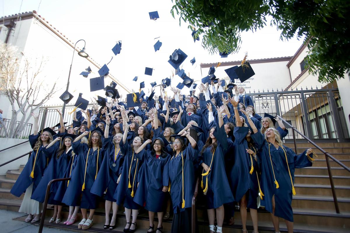 Students gather on the steps of Mission Prep school to toss their mortarboards for a photo before the ceremony begins. Eighty-three Mission Prep students graduated in San Luis Obispo, earning nearly $2 million in scholarships.