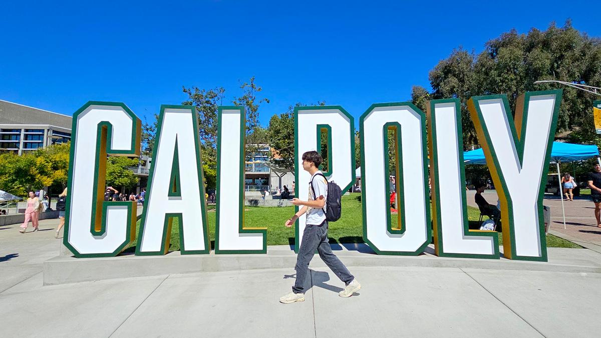 Students walk past the Cal Poly sign in the University Union on Sept. 24, 2024.
