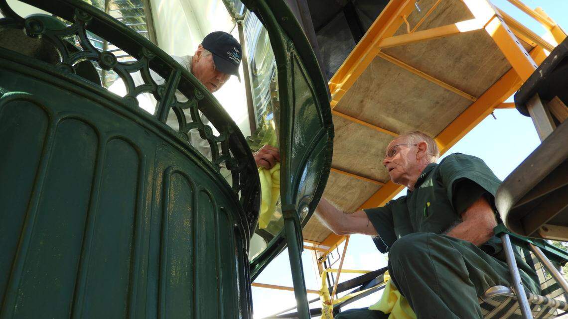 Phil Adams, left, and Jim Woodward polish a prism inside the Piedras Blancas Lighthouse lens.