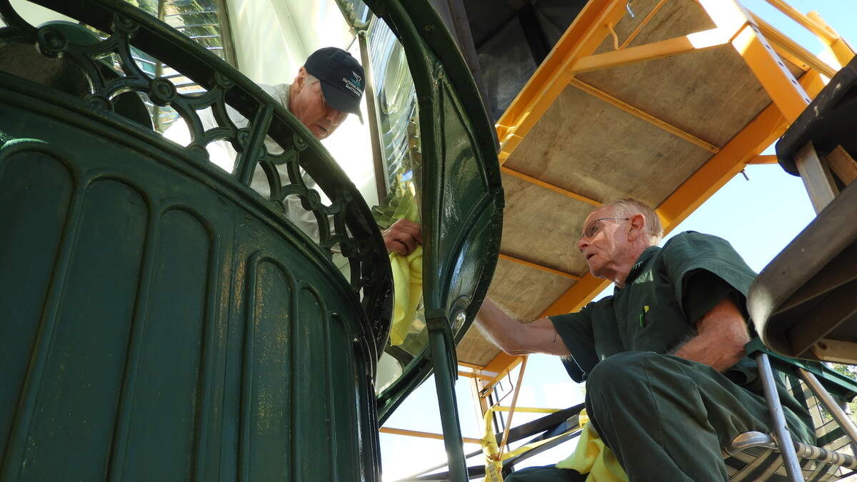 Phil Adams, left, and Jim Woodward polish a prism inside the Piedras Blancas Lighthouse lens.