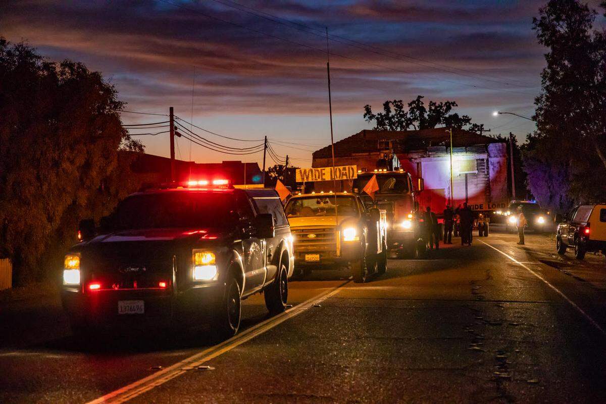 A 103-year-old colony house, built when Atascadero was being established in 1915, is transported down El Camino Real to its new home at a local museum.