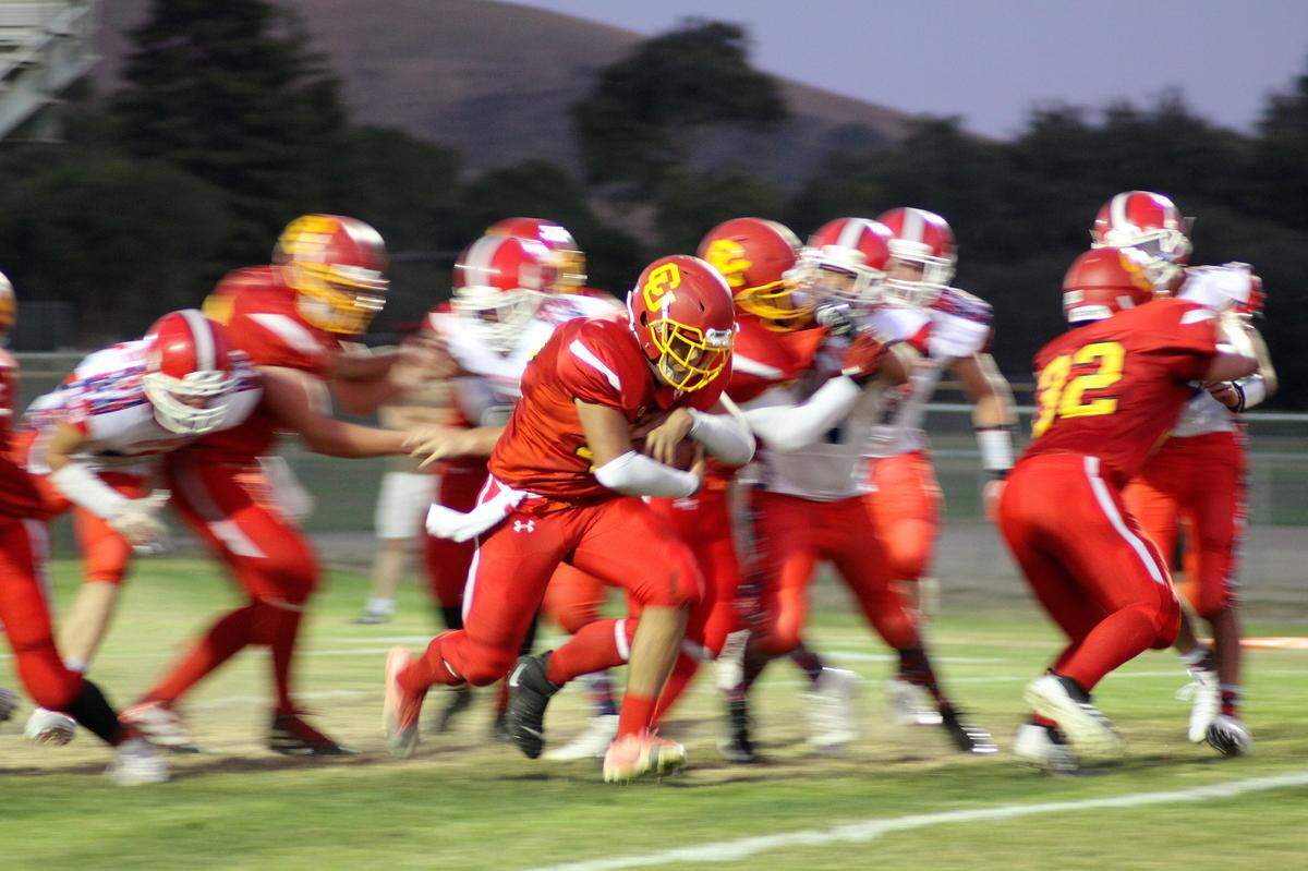 Coast Union High School running back Damien Fernandez gained 45 yards and caught three passes for 55 yards and two touchdowns in the Broncos’ 68-28 win over Crystal Springs Upland on Saturday, Oct. 5. Here he chews up yardage against Riverdale earlier this season.